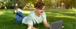 cheerful-student-guy-doing-homework-with-laptop-an-2021-12-09-11-14-31-utc 1